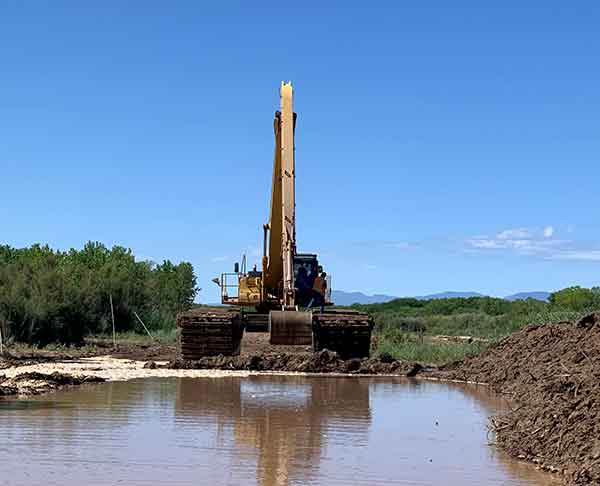 The Socorro Construction crew excavates a new pilot channel in October around a plug that formed in the Rio Grande south of Socorro, New Mexico in the Bosque del Apache Wildlife Refuge.