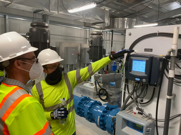 Reclamation staff inspect the effluent water quality readout during Monitored Testing 2 of the Cutter Lateral Water Treatment Plant