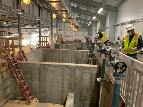 Contractor staff installing wiring to valve actuators on the filter bays in Cutter Lateral Water Treatment Plant