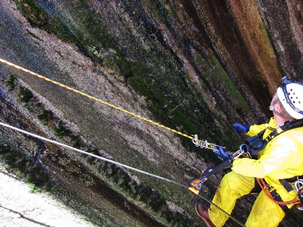 Oran Hatch (BOR Plant Mechanic Apprentice at Flaming Gorge Dam) inspecting calcite buildup prior to removal