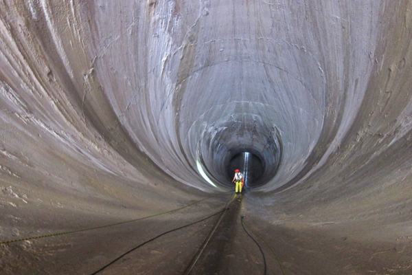 Frederick Busch rappelling into spillway tunnel to inspect and repair concrete.