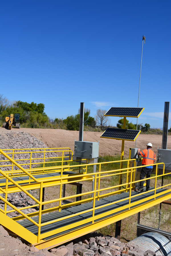 Bryan Lawlis, AAO Project Management Specialist, walks on the catwalk to check the gate actuators