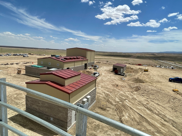Two red roofed building of Tooh Haltsooi Pumping Plant.